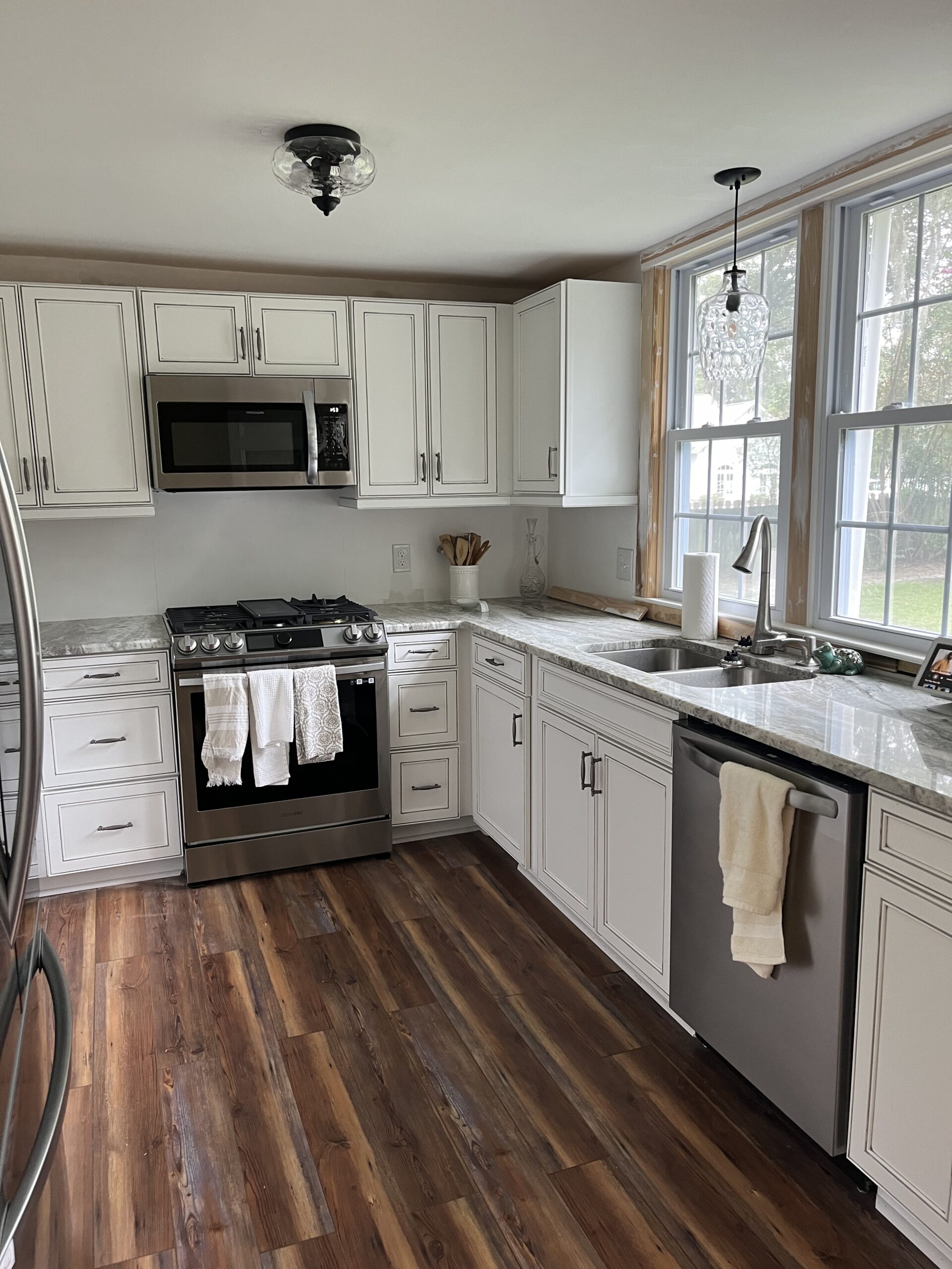 A kitchen featuring a sink, stove, and refrigerator, showcasing a functional cooking space
